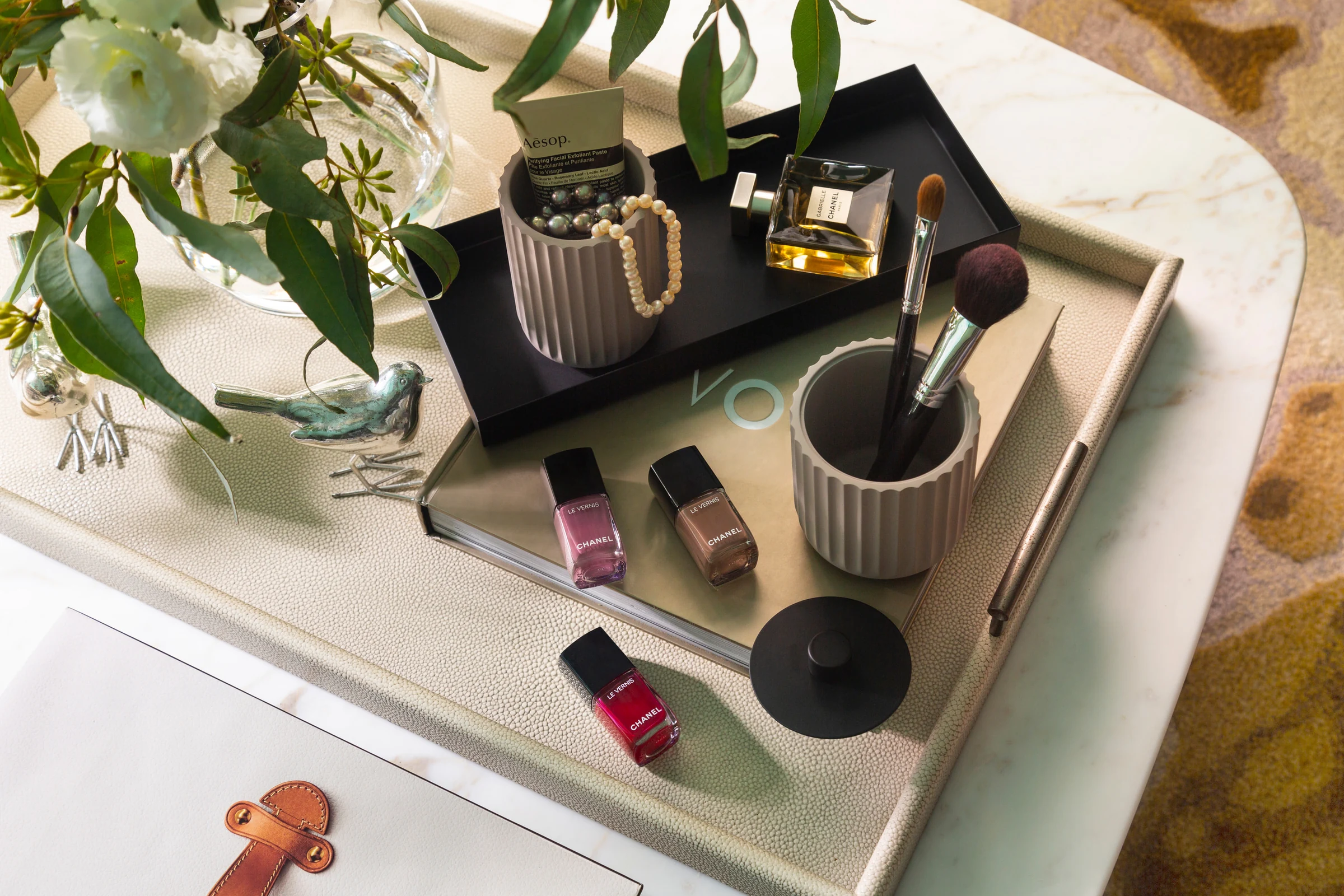 Beauty products, perfume and makeup brushes styled on a tabletop