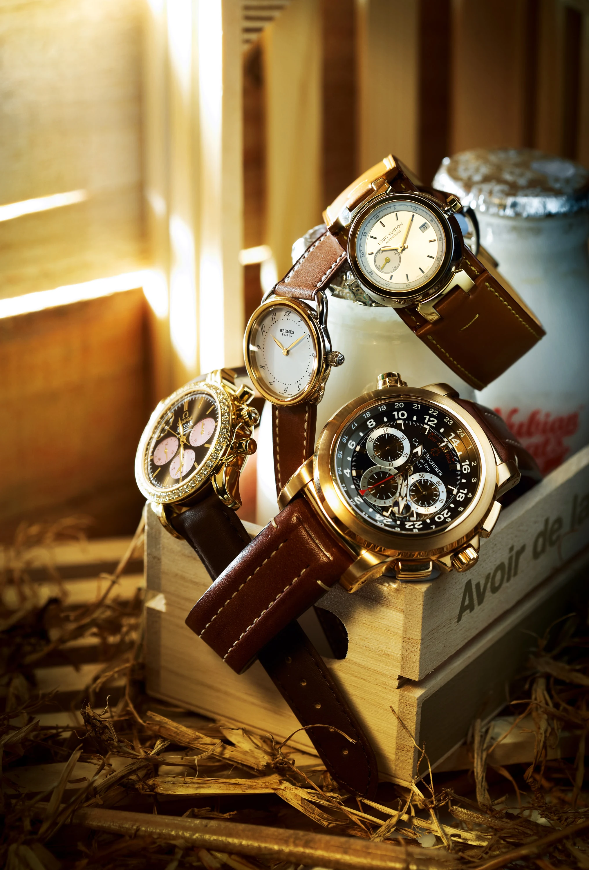 Luxury watches arranged in warm directional light