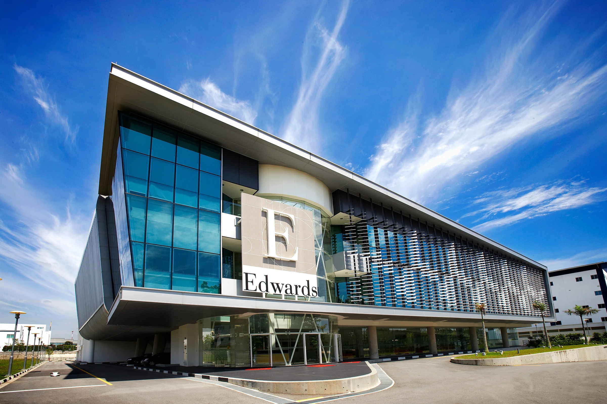 Modern commercial building exterior beneath a blue sky